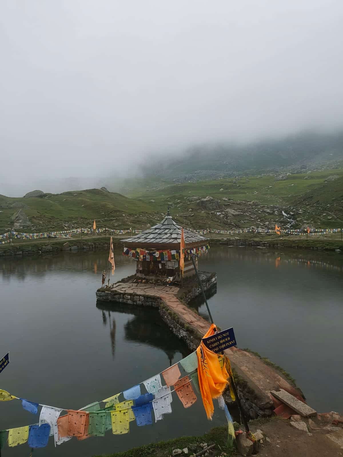 Yulla Kanda Trek Guide (2026): Cost, Route & Return The small Krishna temple at the edge of Yulla Kanda lake